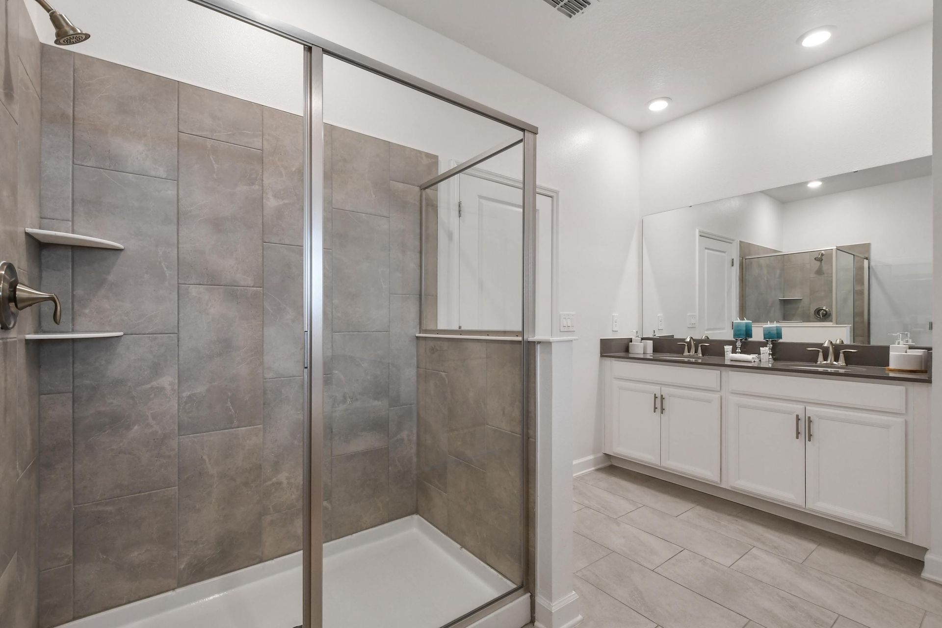 Contemporary bathroom with large walk-in shower, double vanity, and modern finishes.
