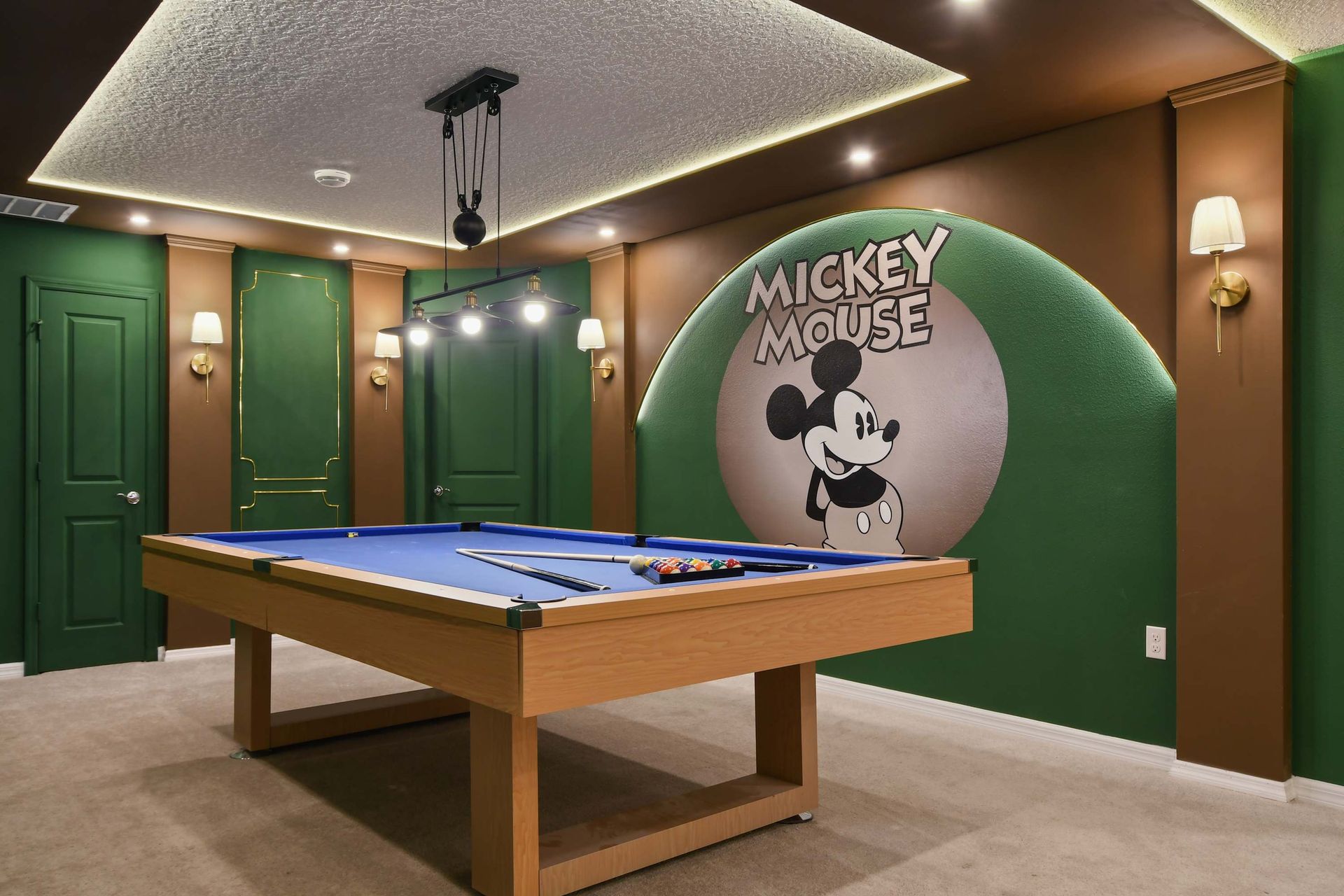 Mickey Mouse-themed game room with a pool table and stylish decor!
