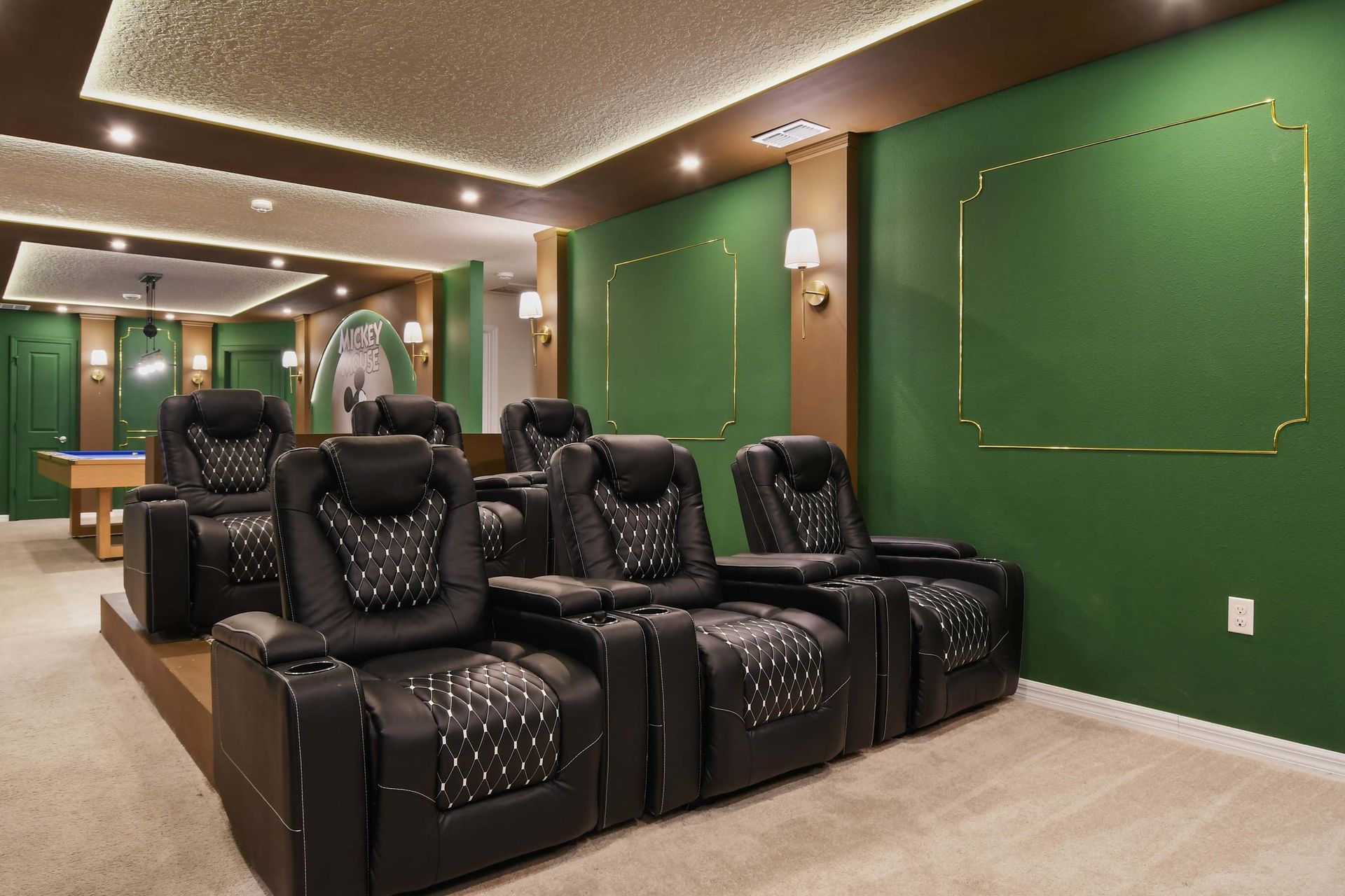 Charming Disney-themed home theater with cozy recliners and magic!