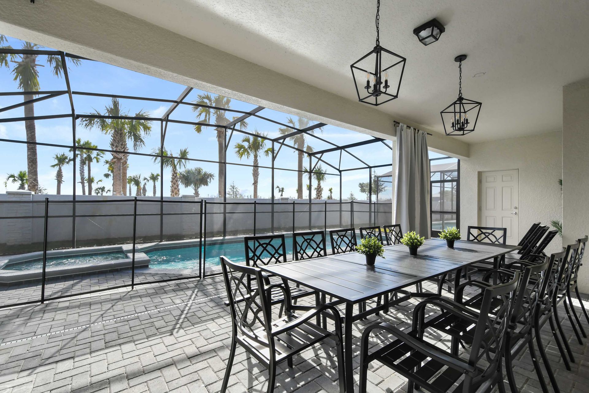 Beautiful patio with screened pool, dining area, and sunny views!