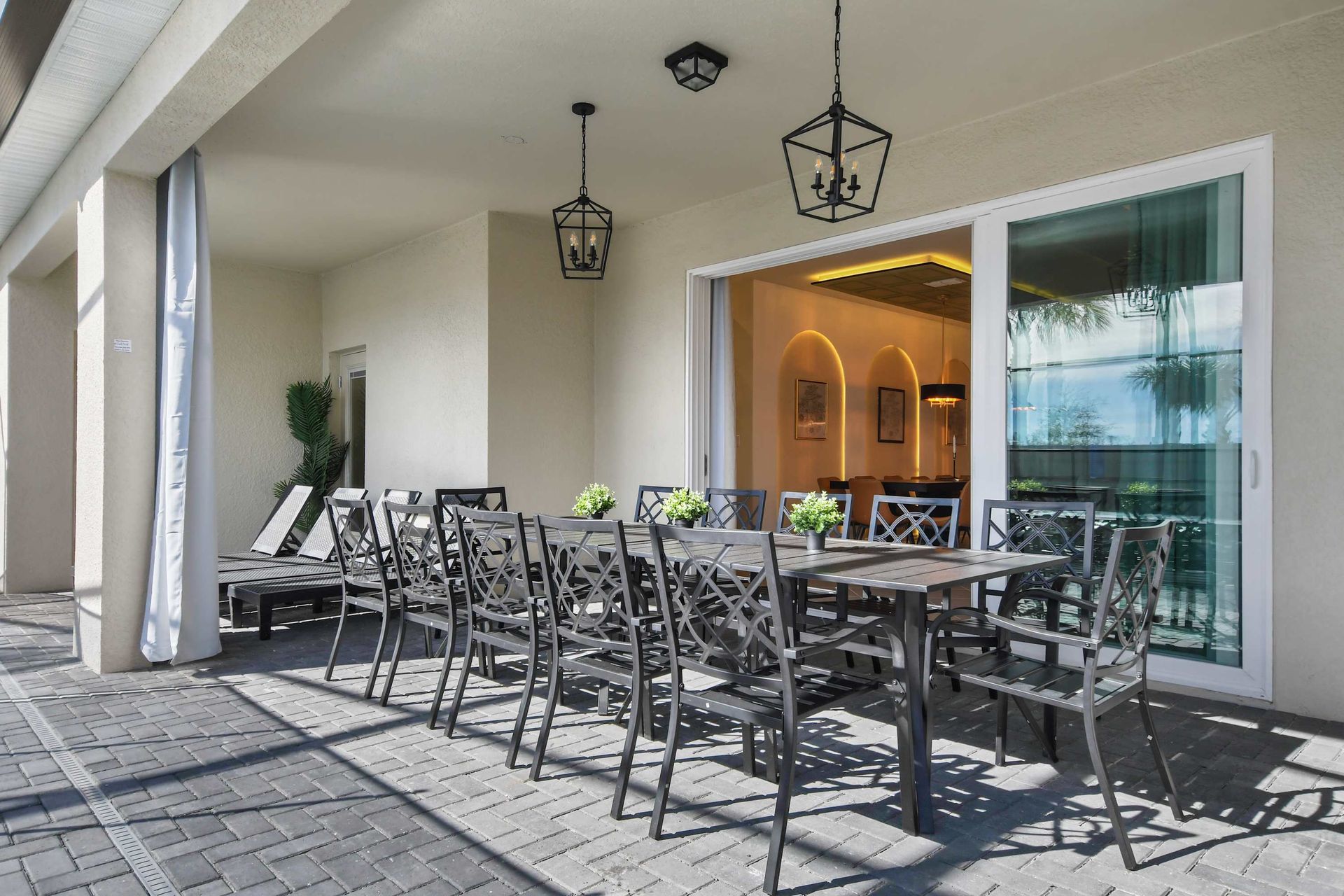 Relax by the pool on this stylish screened patio with dining and lounge areas!