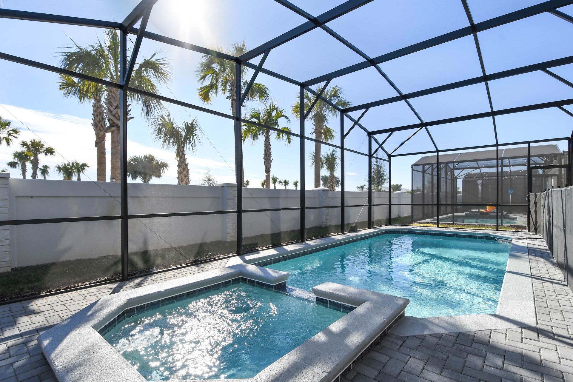 Relax in this private screened pool and spa with sunny palm views!