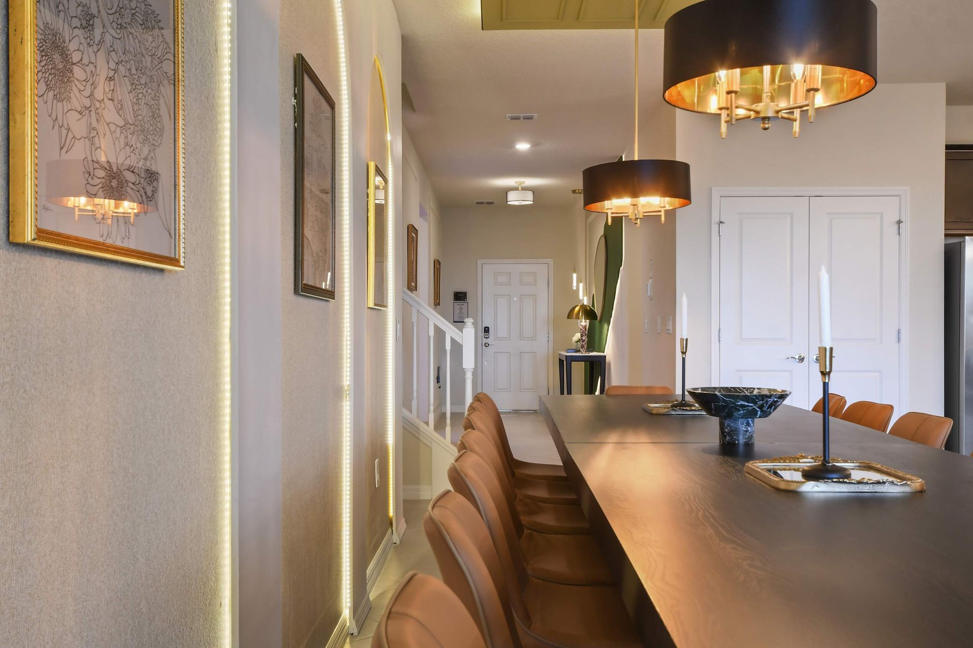 Elegant entryway and dining space with warm lighting and decor!