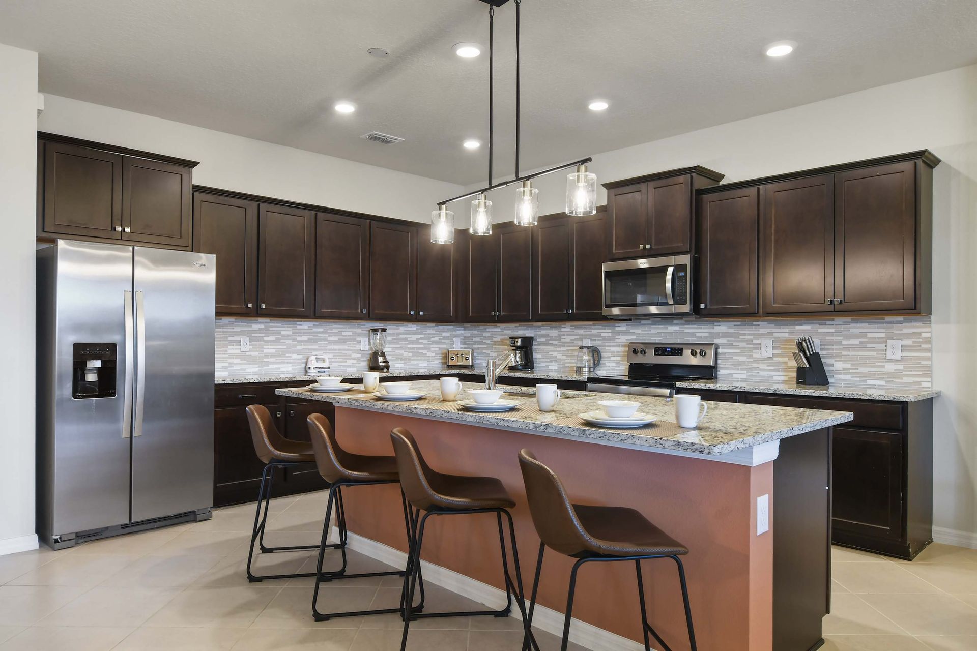 Modern kitchen with granite counters, bar seating, and sleek design!