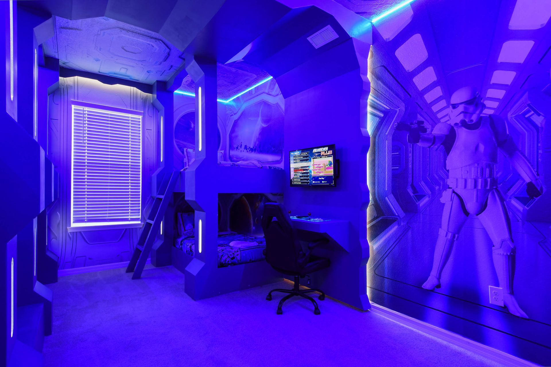 Futuristic Star Wars-themed room with glowing bunk beds and gaming!