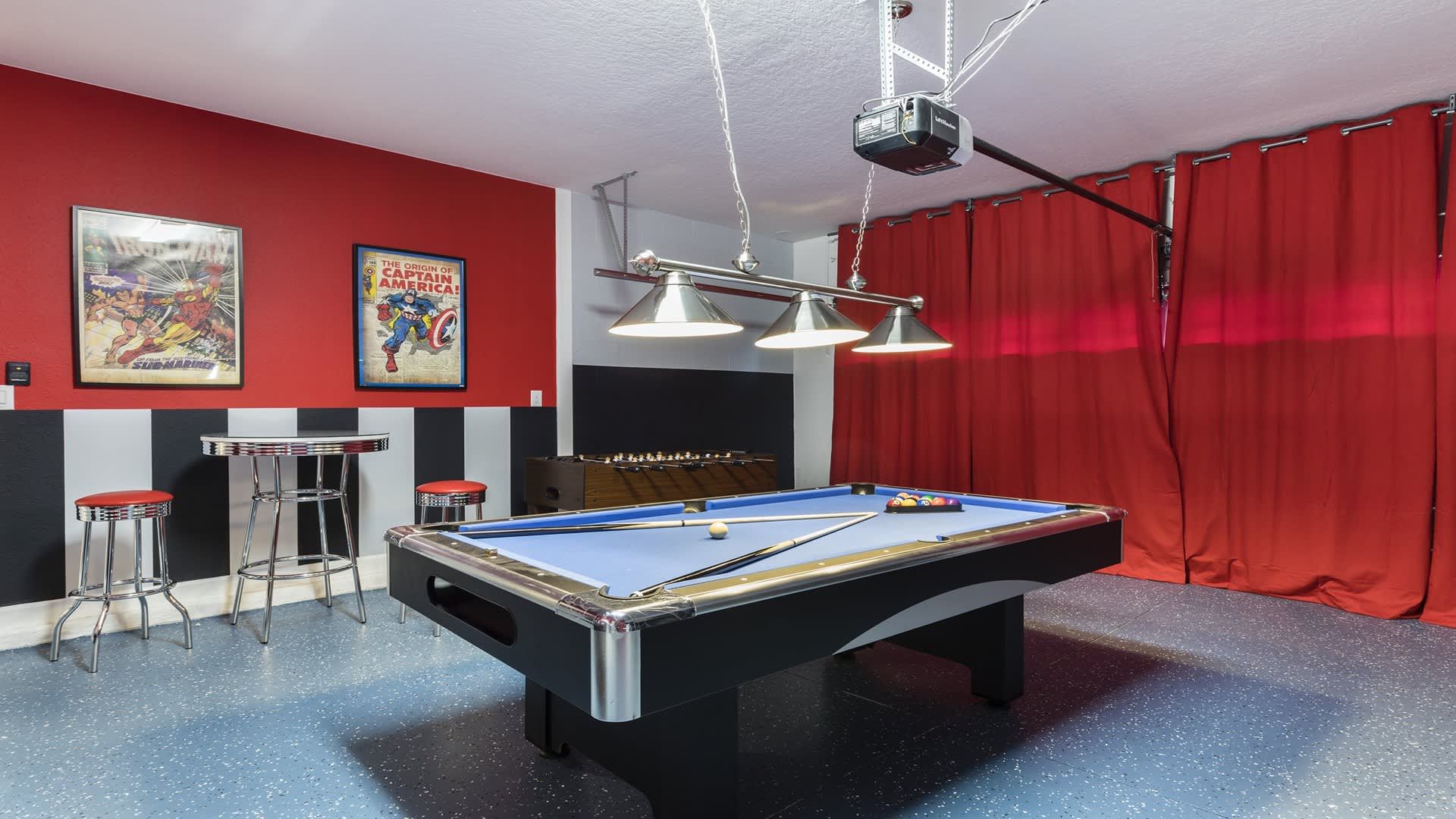 Game room with pool table, foosball, air hockey, and bold red accents.