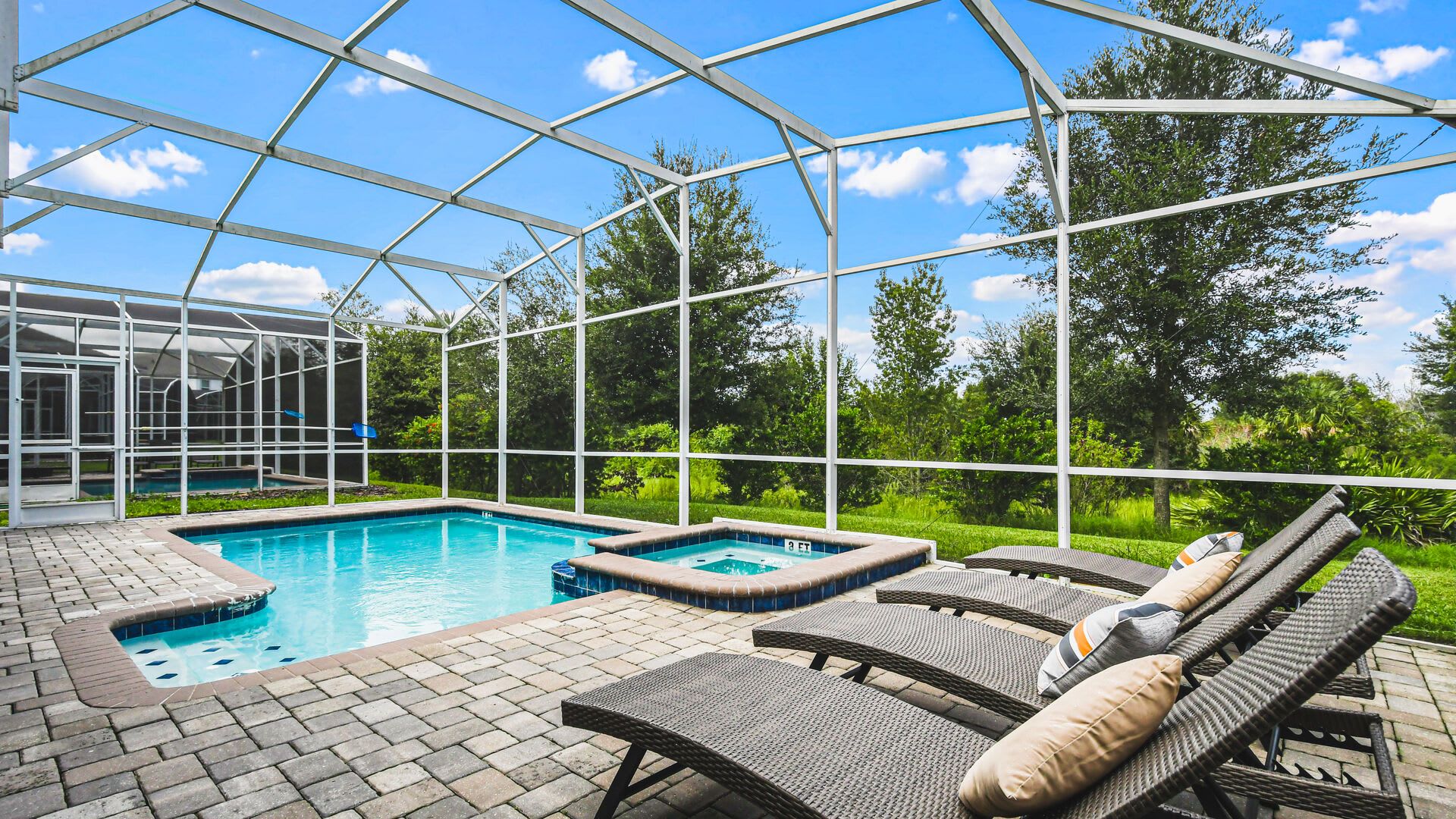 Relax in the private screened pool and spa with lush views and sunny loungers.