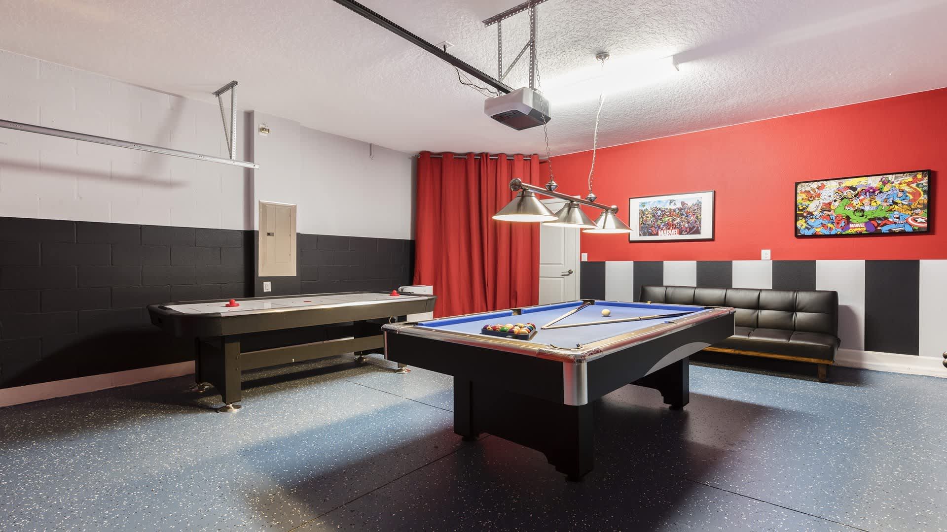 Spacious game room with pool table, air hockey, foosball, and vibrant decor.