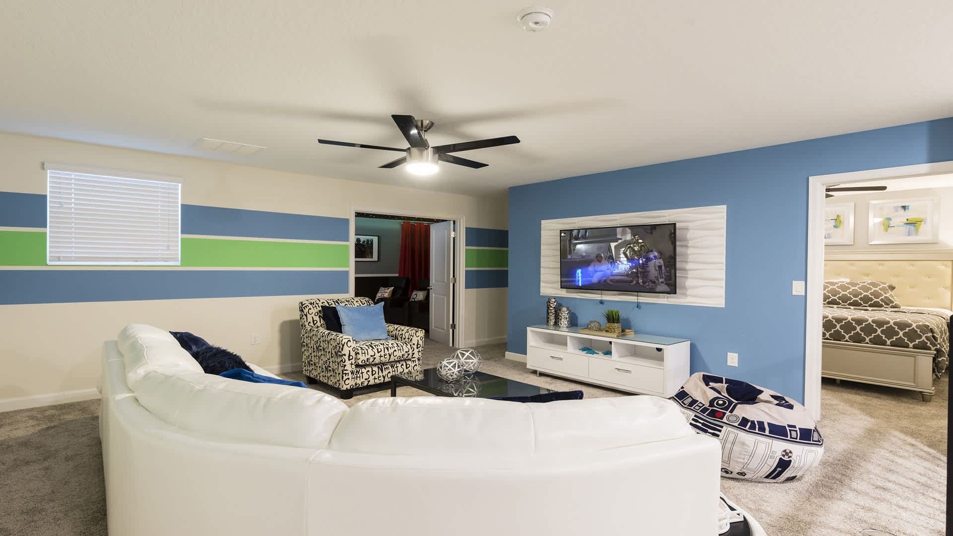 Colorful upstairs loft with cozy seating, perfect for movies and relaxation.