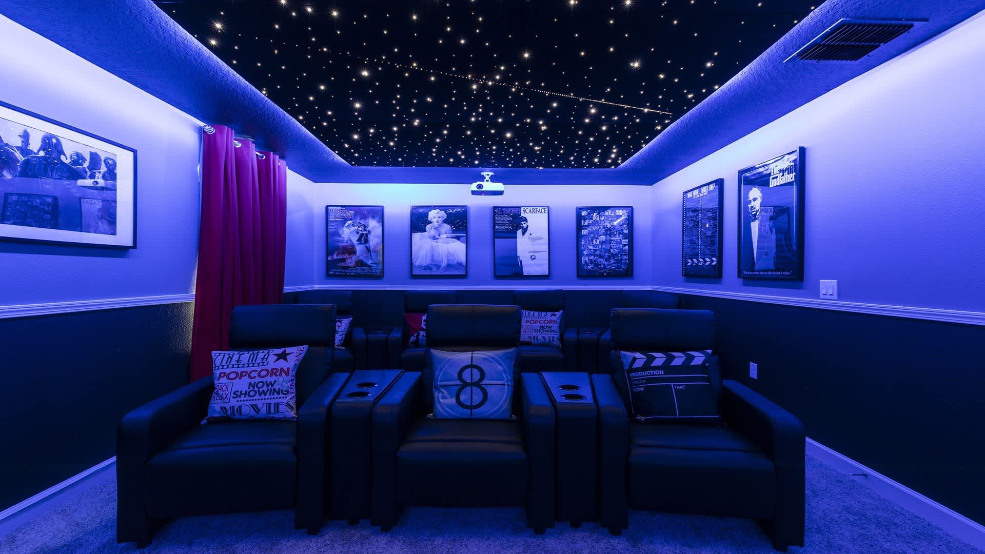 Private movie theater with starry ceiling, reclining seats, and immersive lighting.