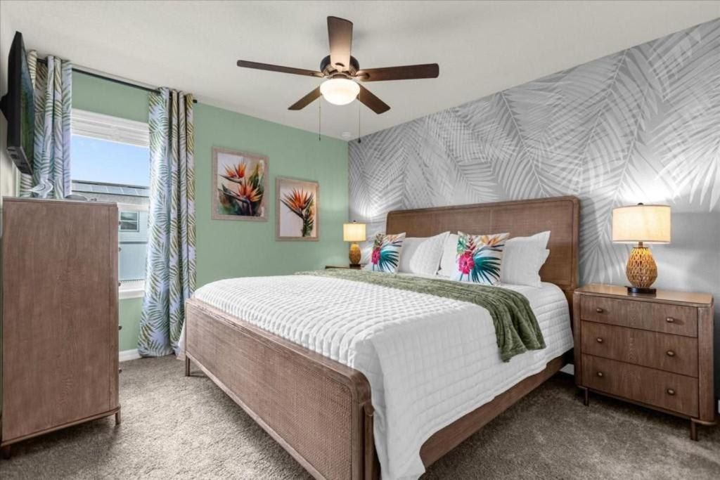 Tropical-themed king bedroom with cozy textures, palm accents, and vibrant decor.