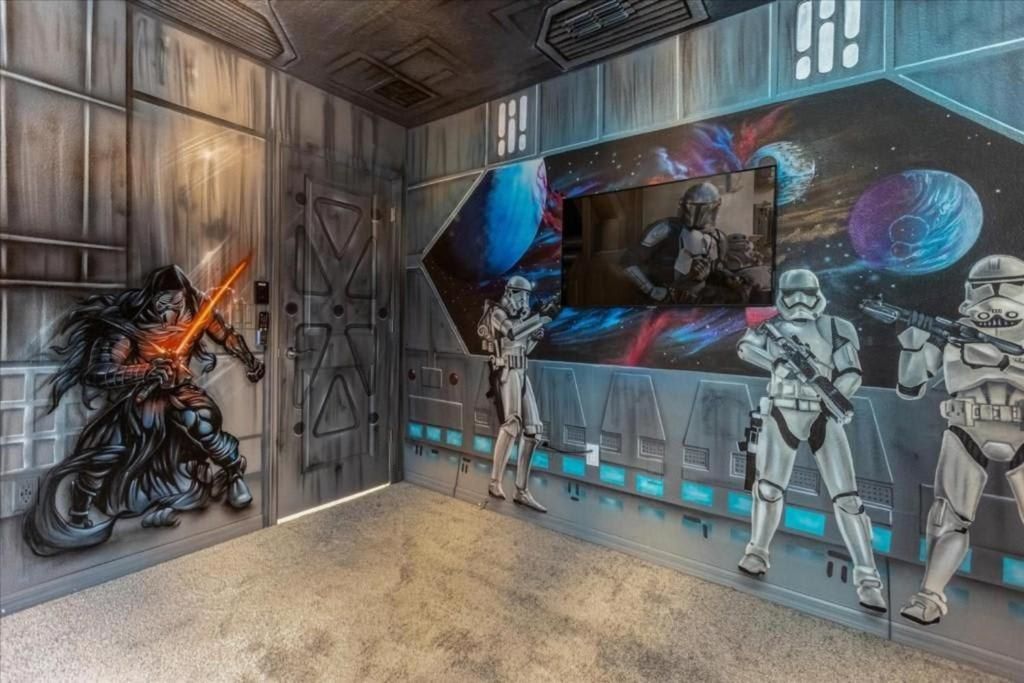 Galactic-themed media room with space murals, star warriors, and immersive sci-fi vibes.