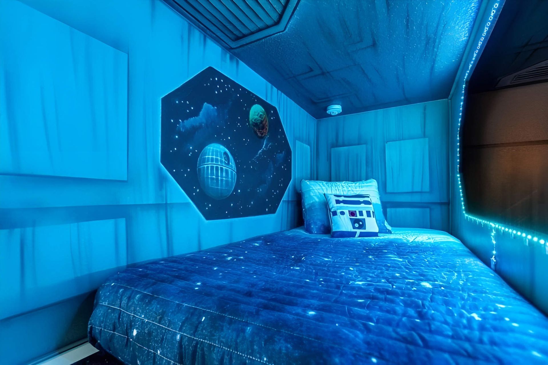 Futuristic bunk bed with glowing lights, galaxy walls, and an out-of-this-world theme.
