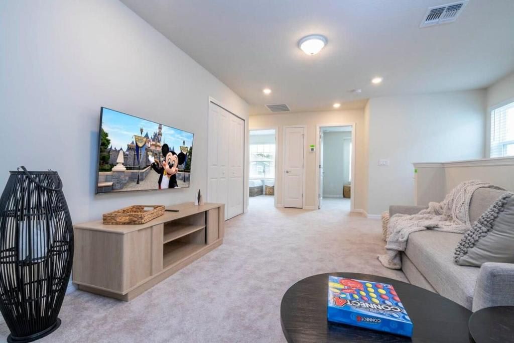 Spacious living area with cozy seating, TV, and a relaxed ambiance.