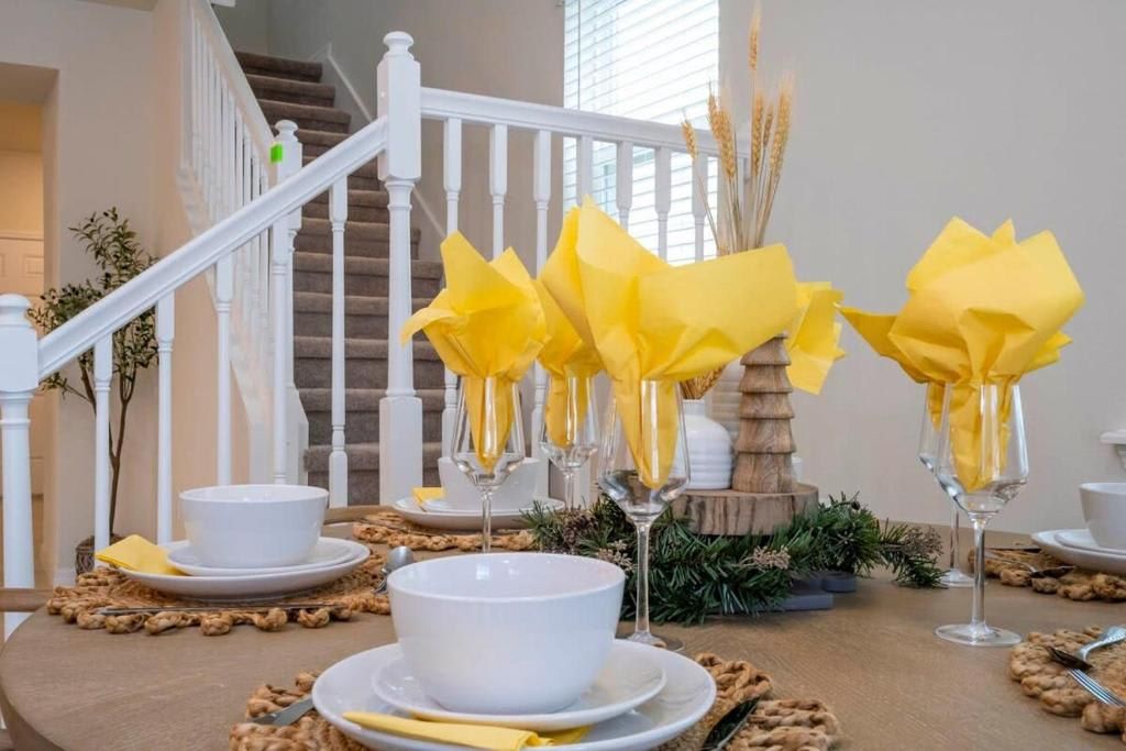 Charming dining setup with bright yellow napkins and elegant tableware.