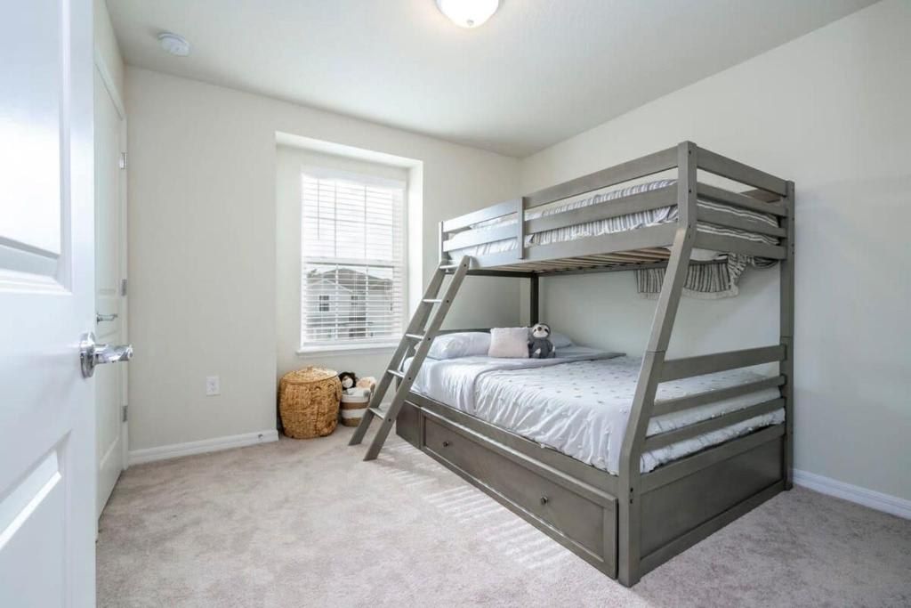 Bright and airy room featuring a functional bunk bed with clean, simple design.