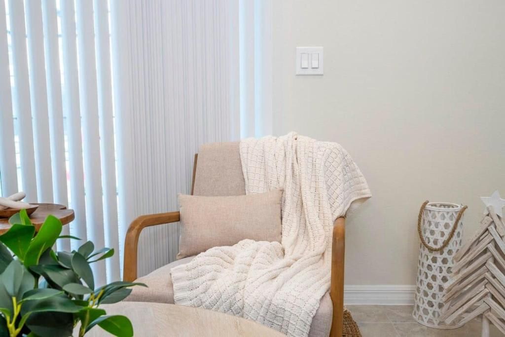 Cozy reading nook with a comfortable chair, soft throw, and calming ambiance.