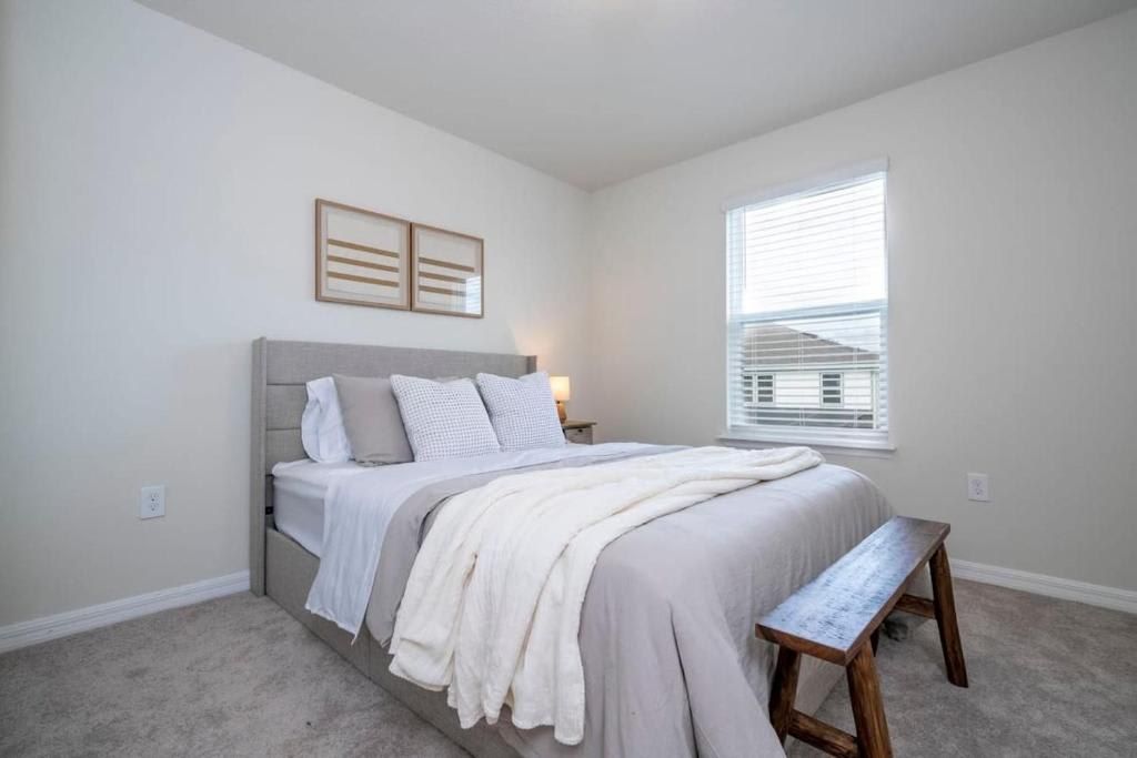 Serene and inviting bedroom with a comfortable bed, soft linens, and natural light.