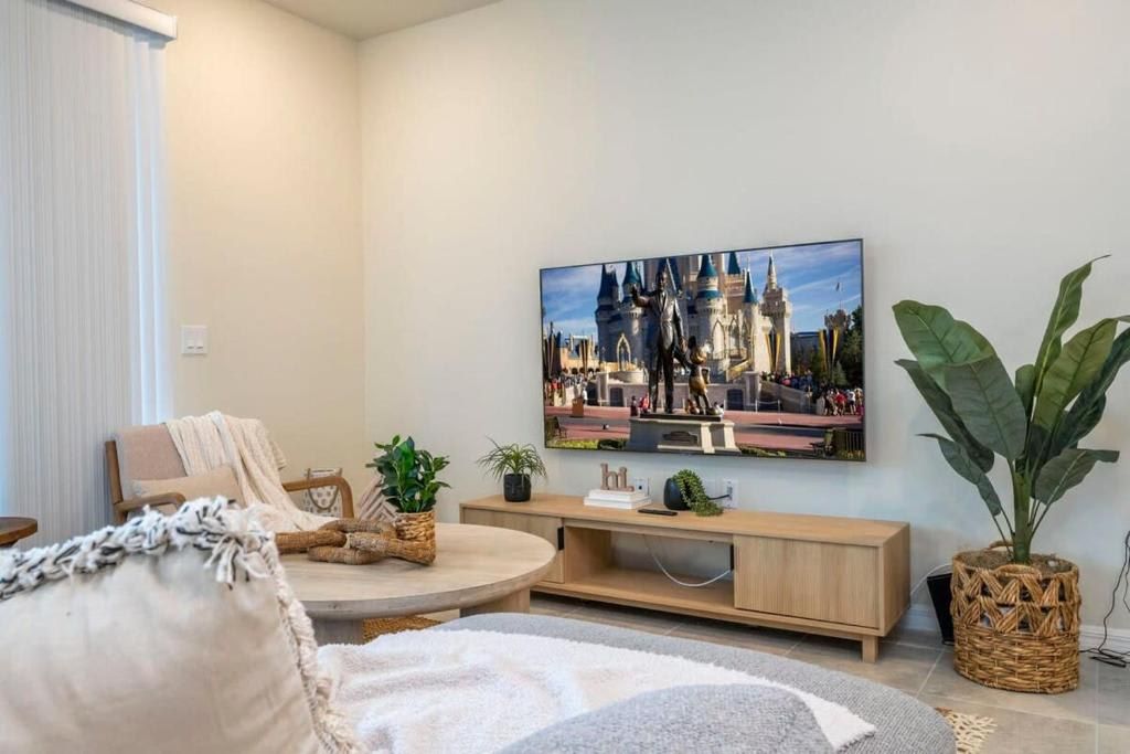 Cozy living room with smart TV, plush seating, and relaxing modern décor.