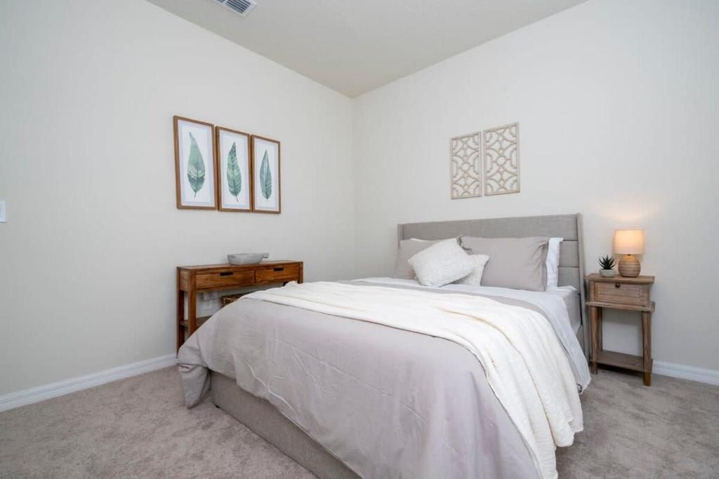 Calming bedroom with soft tones, cozy bedding, and stylish decor accents.
