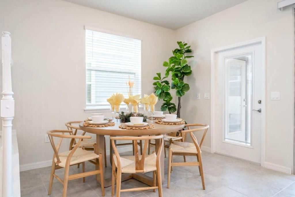 Bright dining area with natural light, stylish seating, and a welcoming vibe.