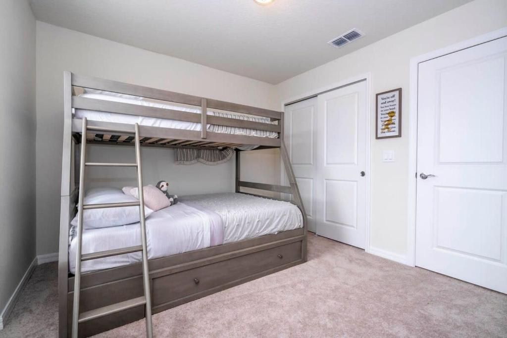 Cozy bedroom with a practical bunk bed setup and neutral, serene decor.