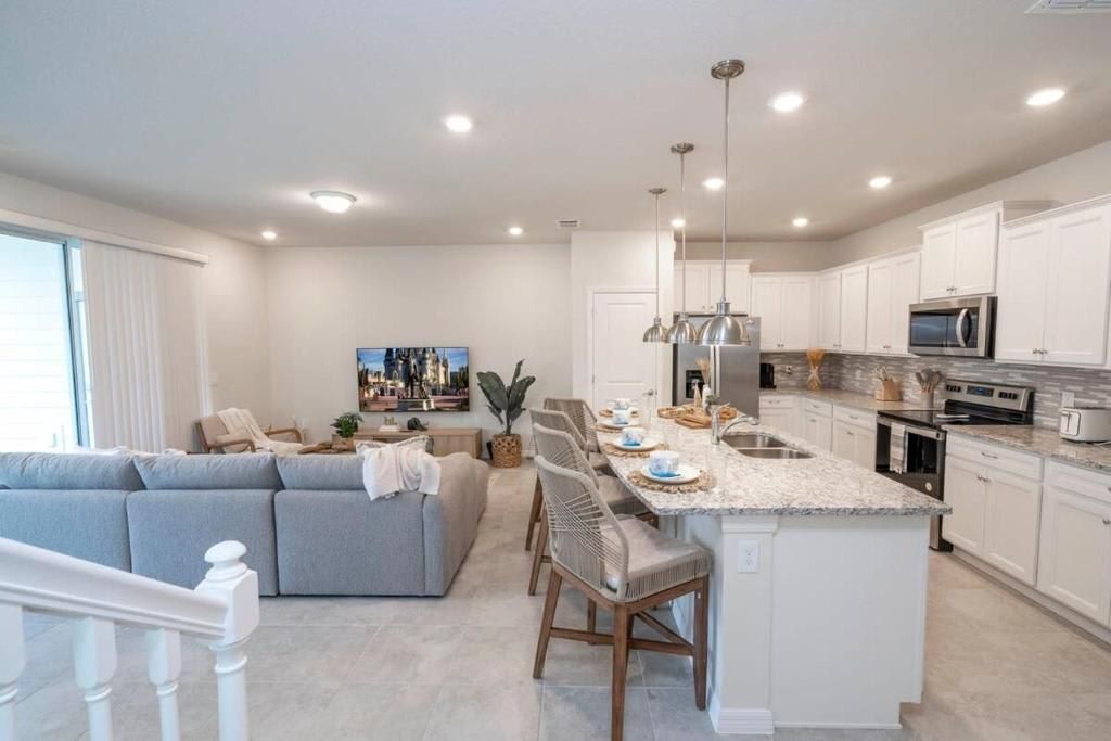 Spacious, modern living room and kitchen with sleek design and cozy seating.