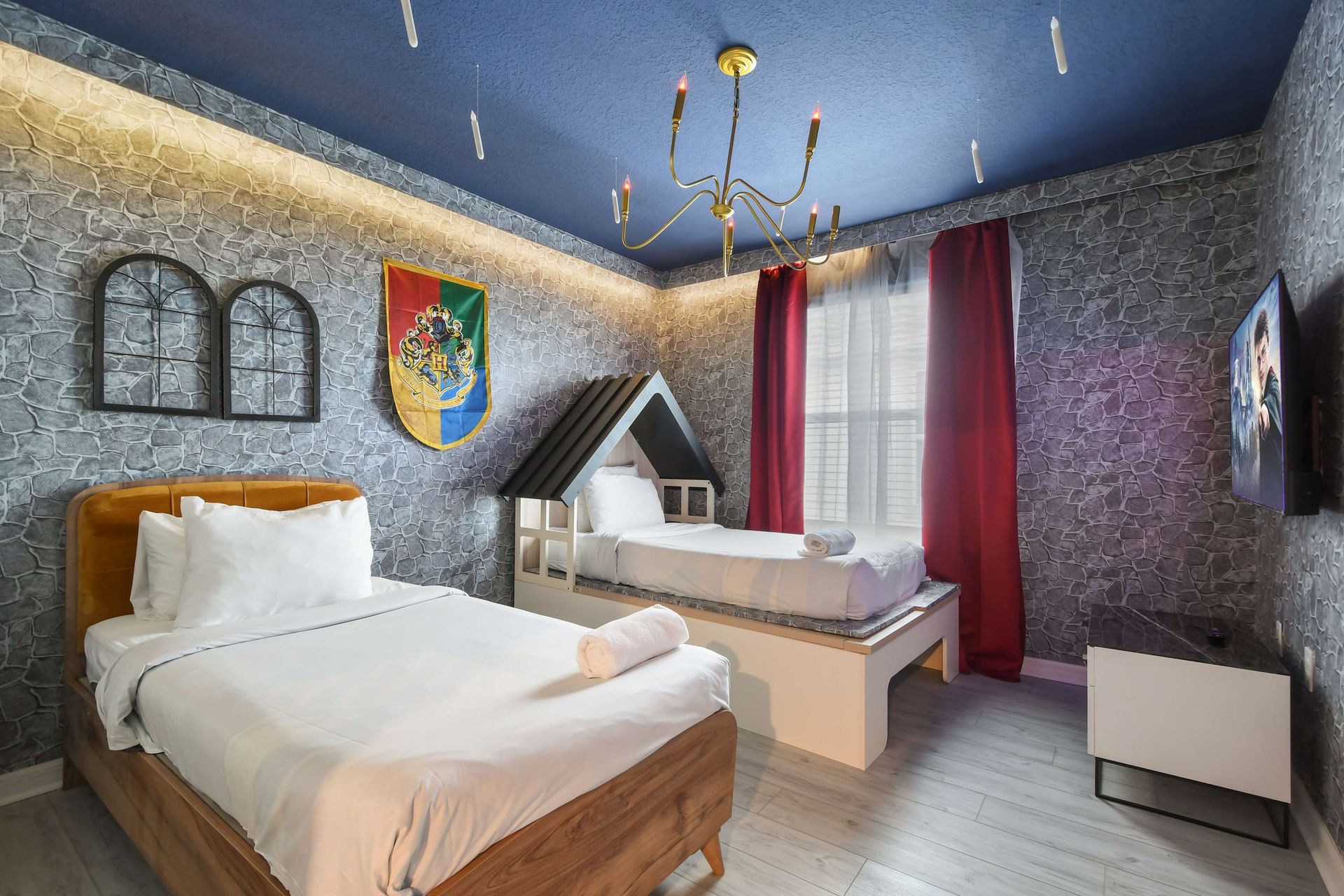 Whimsical wizard-themed room with twin beds, enchanted décor, and magical touches.