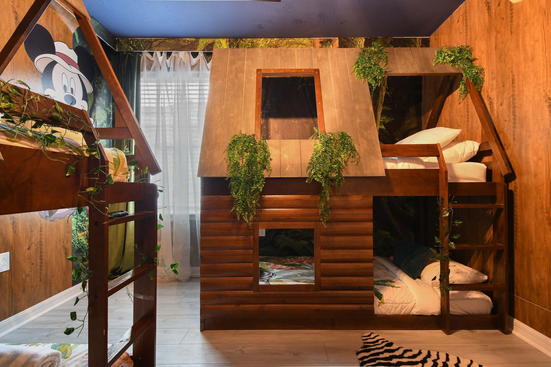 Cozy jungle bunk room with custom treehouse beds, playful vines, and wild charm.