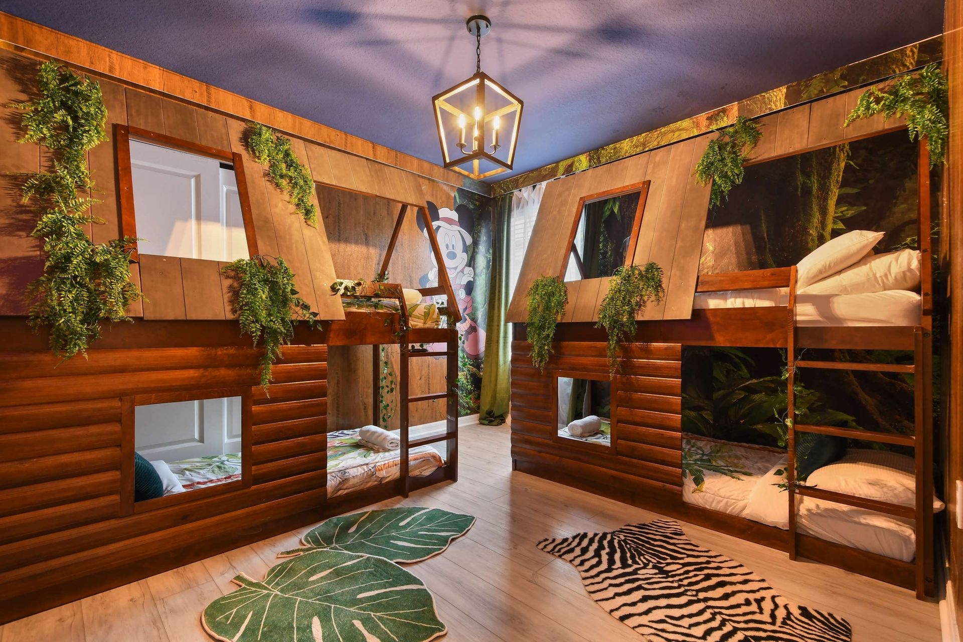 Adventure-filled bunk room with treehouse beds, jungle vines, and safari-style rugs.