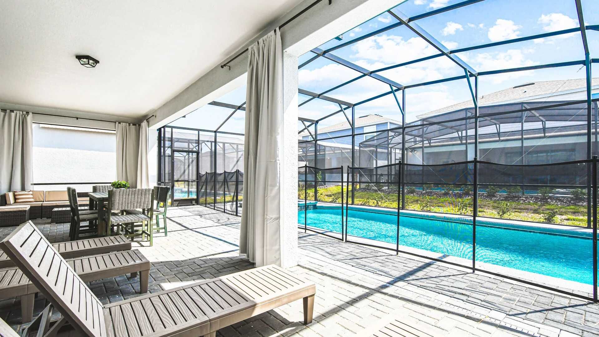 Spacious screened patio with private pool, dining area, loungers, and relaxing vibes.