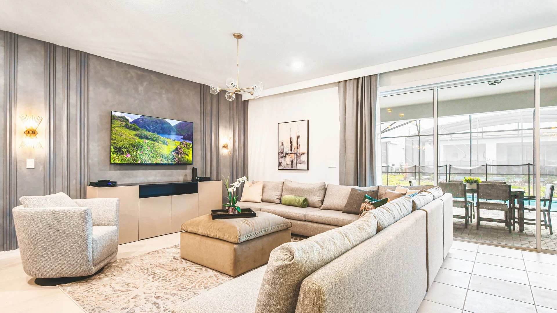 Relax in style in this bright, modern living room with patio and pool views!