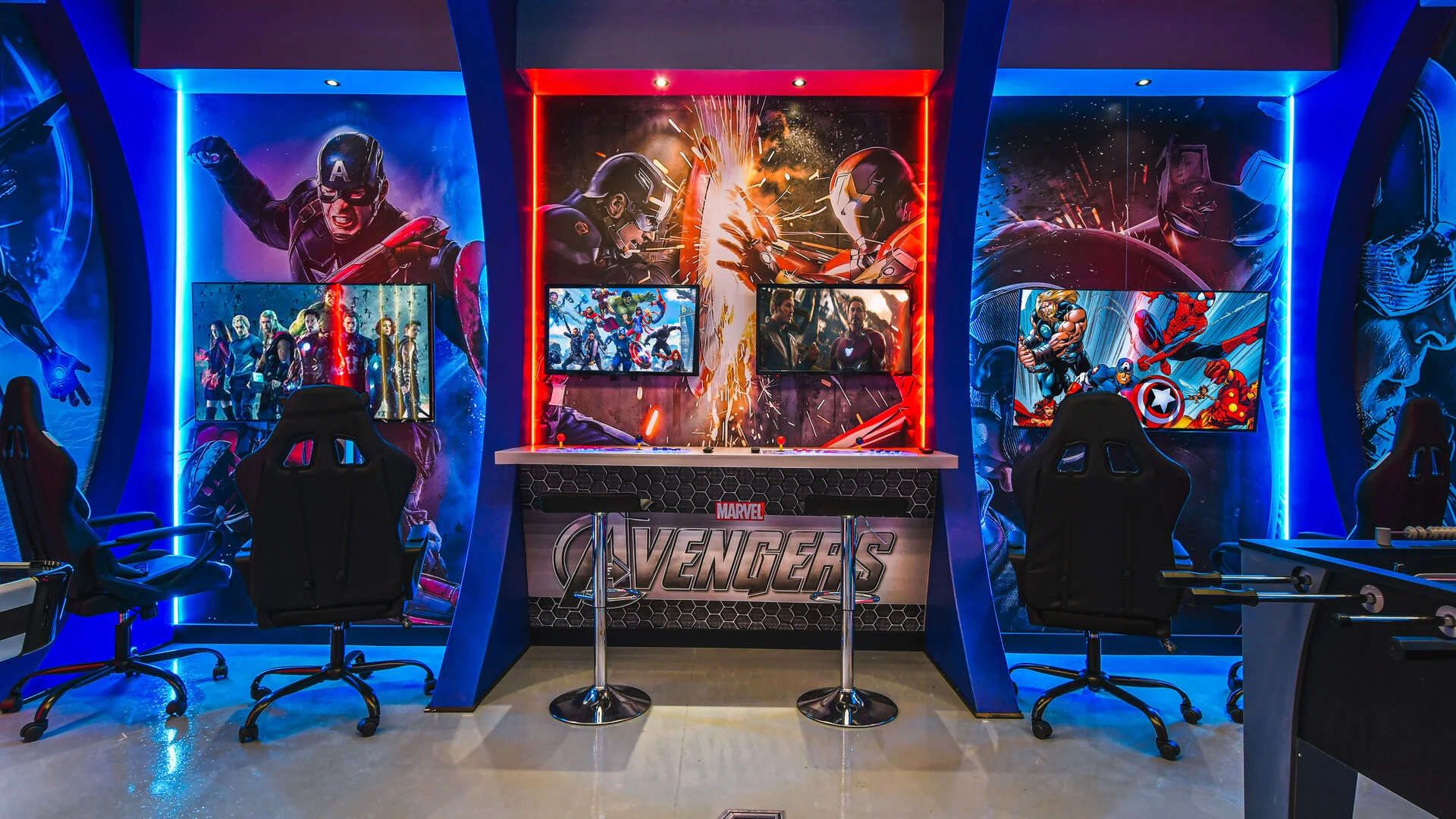 Epic Avengers-themed game room with gaming stations, bold murals, and vibrant LEDs.