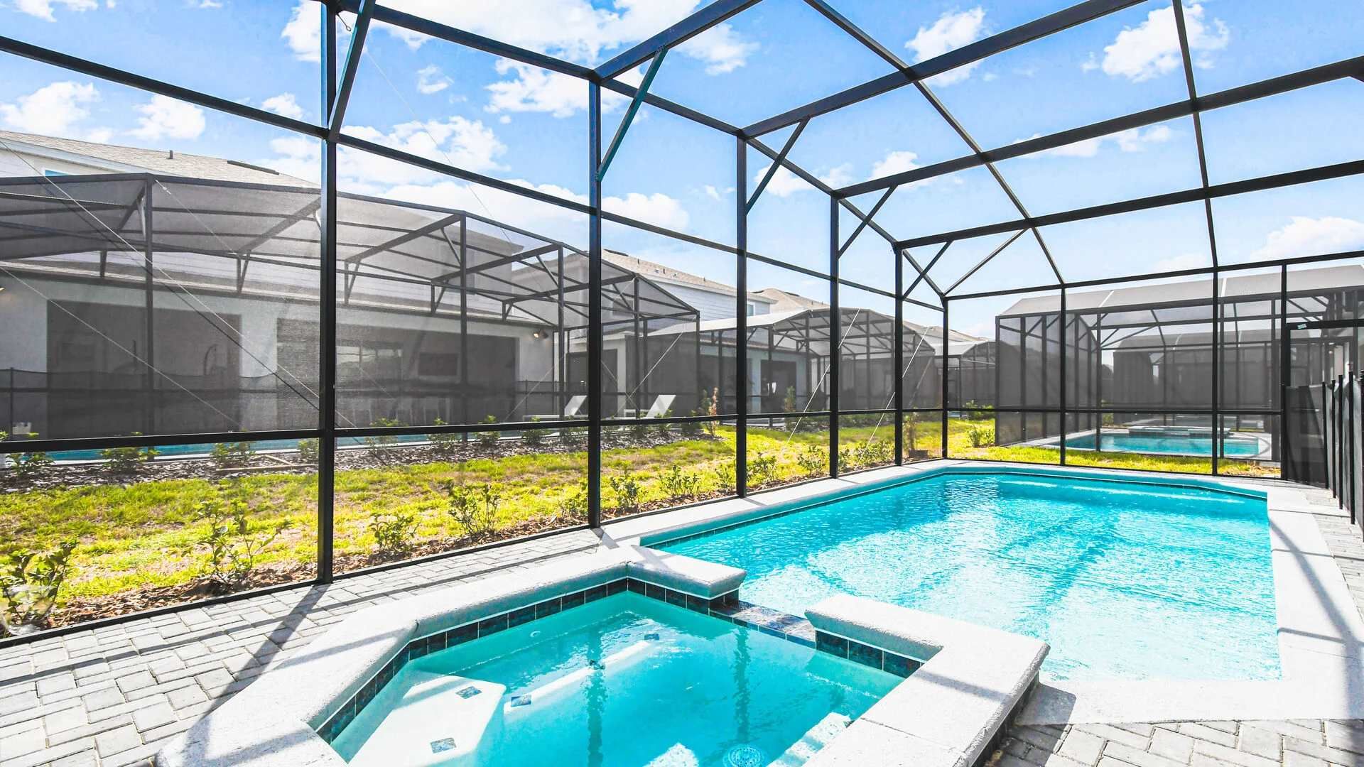 Private screened-in pool and spa with sunny patio, perfect for relaxing or play.