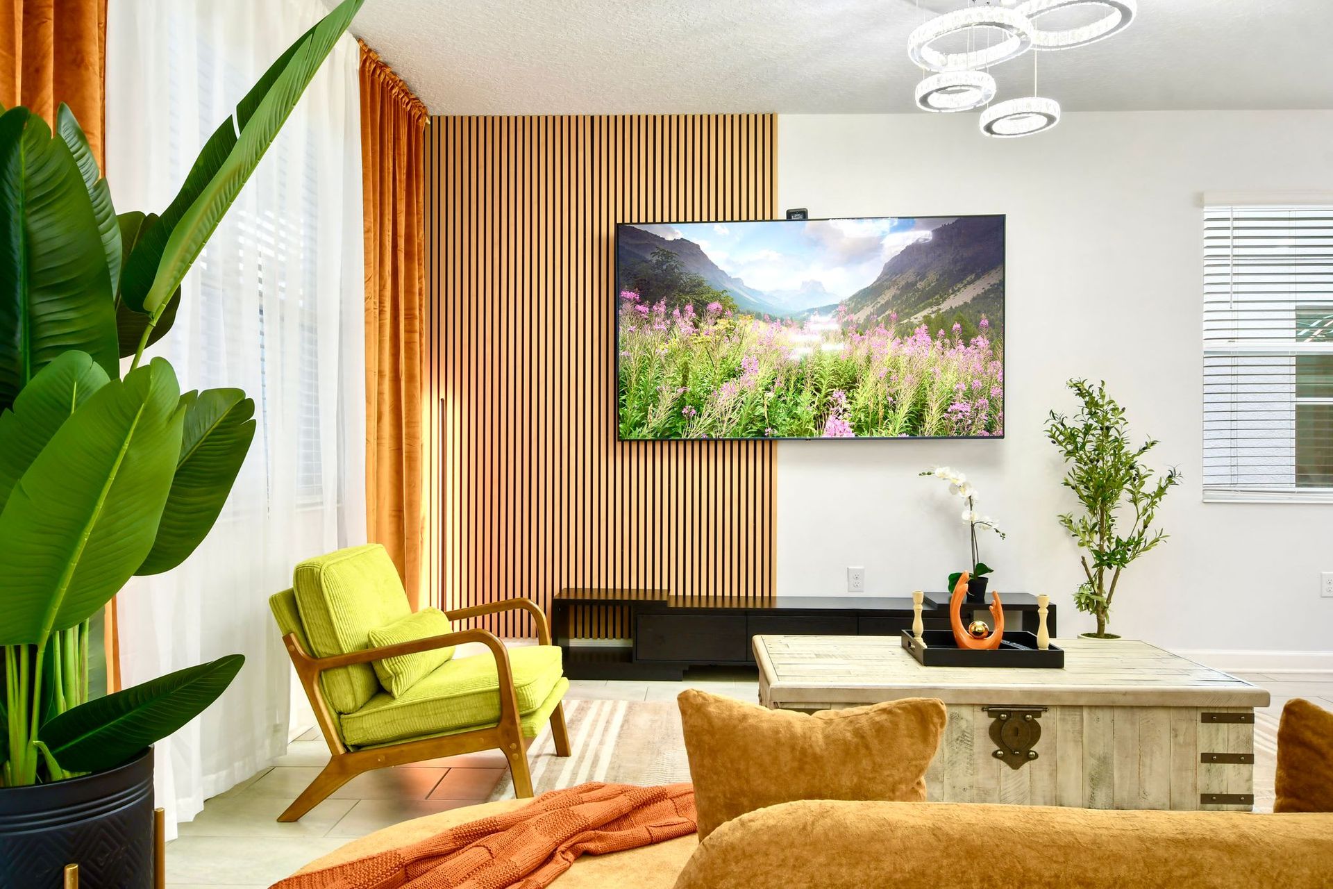 Stylish modern living room with warm tones, lush greenery, and a cozy atmosphere.