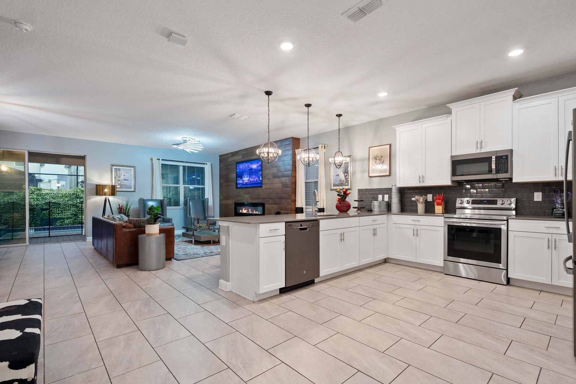 Bright open kitchen with modern finishes, flowing seamlessly into cozy living space!