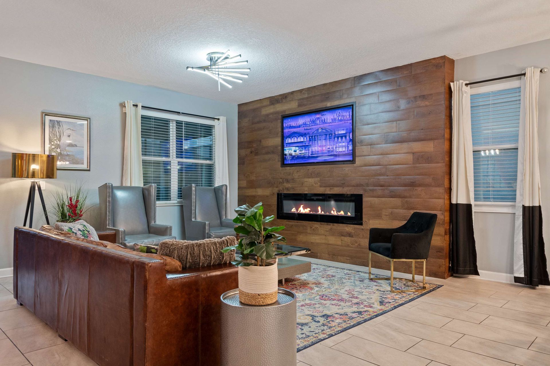 Modern living space with a sleek fireplace, cozy seating, and stylish design touches!