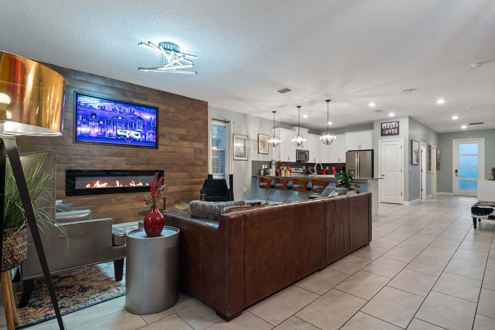 Open-concept elegance with a modern kitchen, cozy fireplace, and stylish lighting!