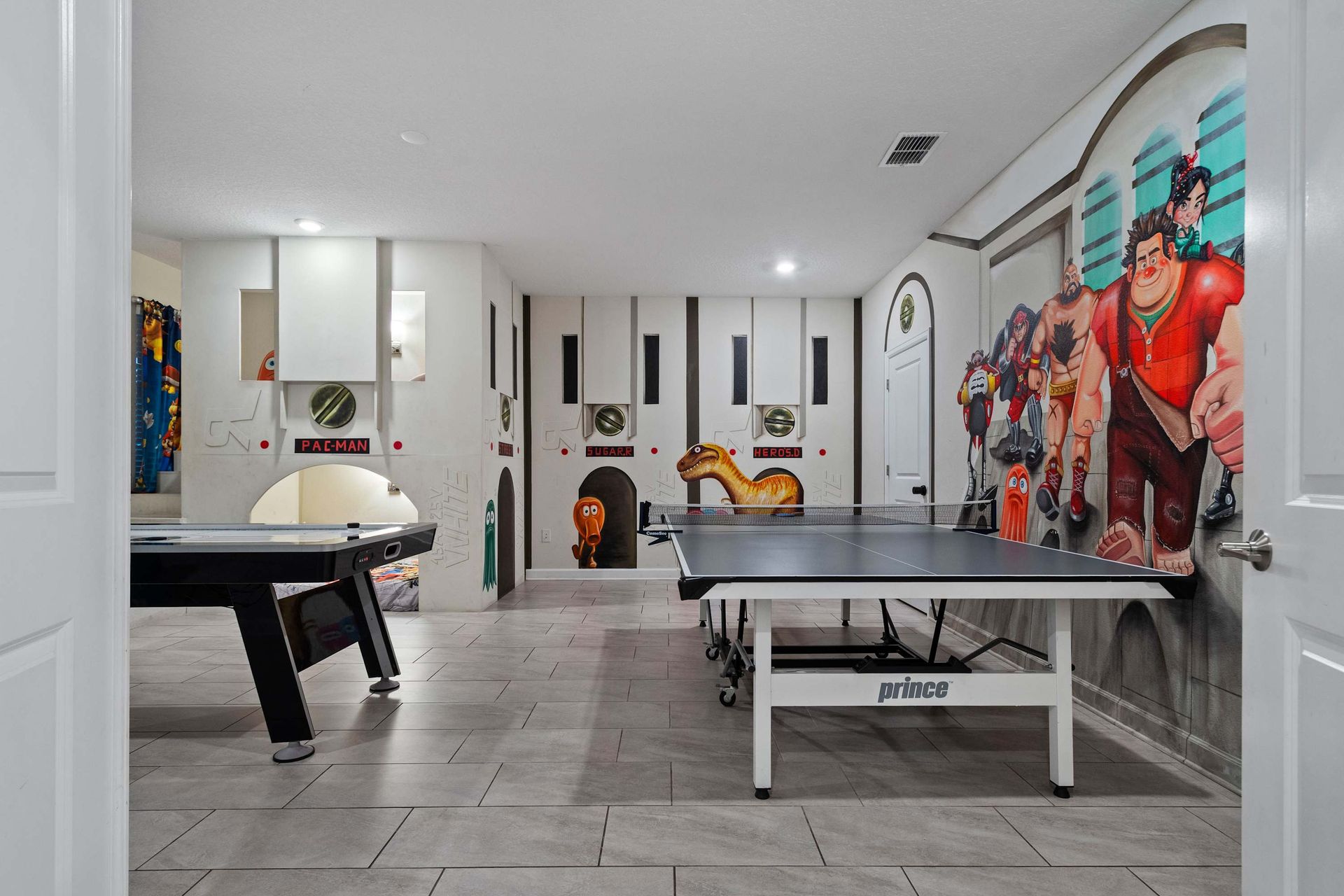 Epic game room with ping pong, air hockey, and bold arcade-style wall art!