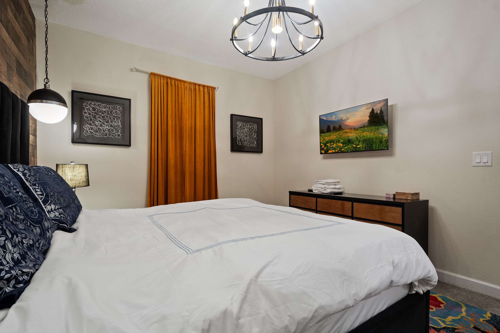 Modern meets cozy in this stylish bedroom with warm accents and inviting decor!