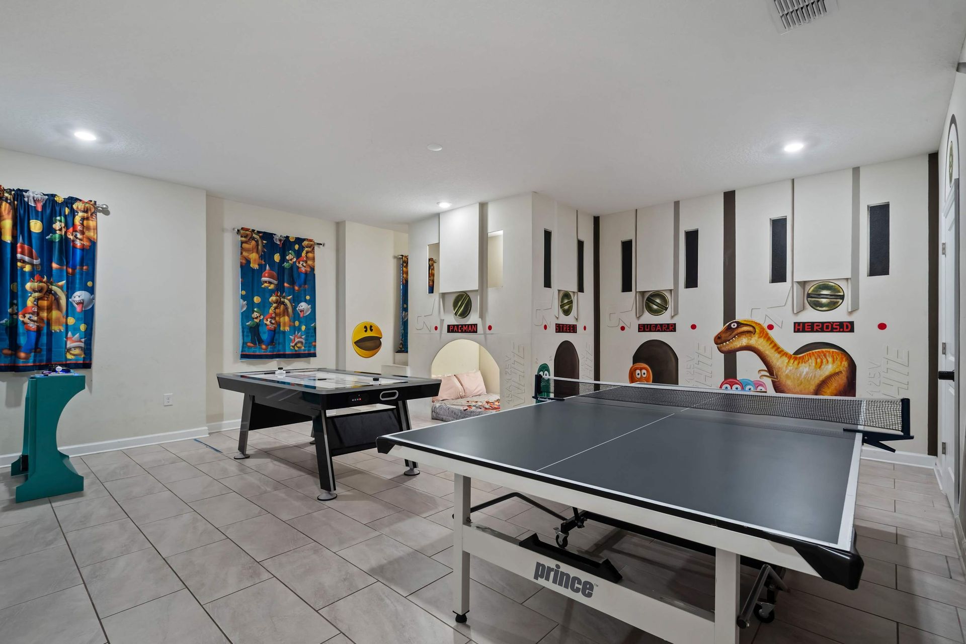 Game on in this vibrant arcade-themed room with ping pong, air hockey, and fun decor!