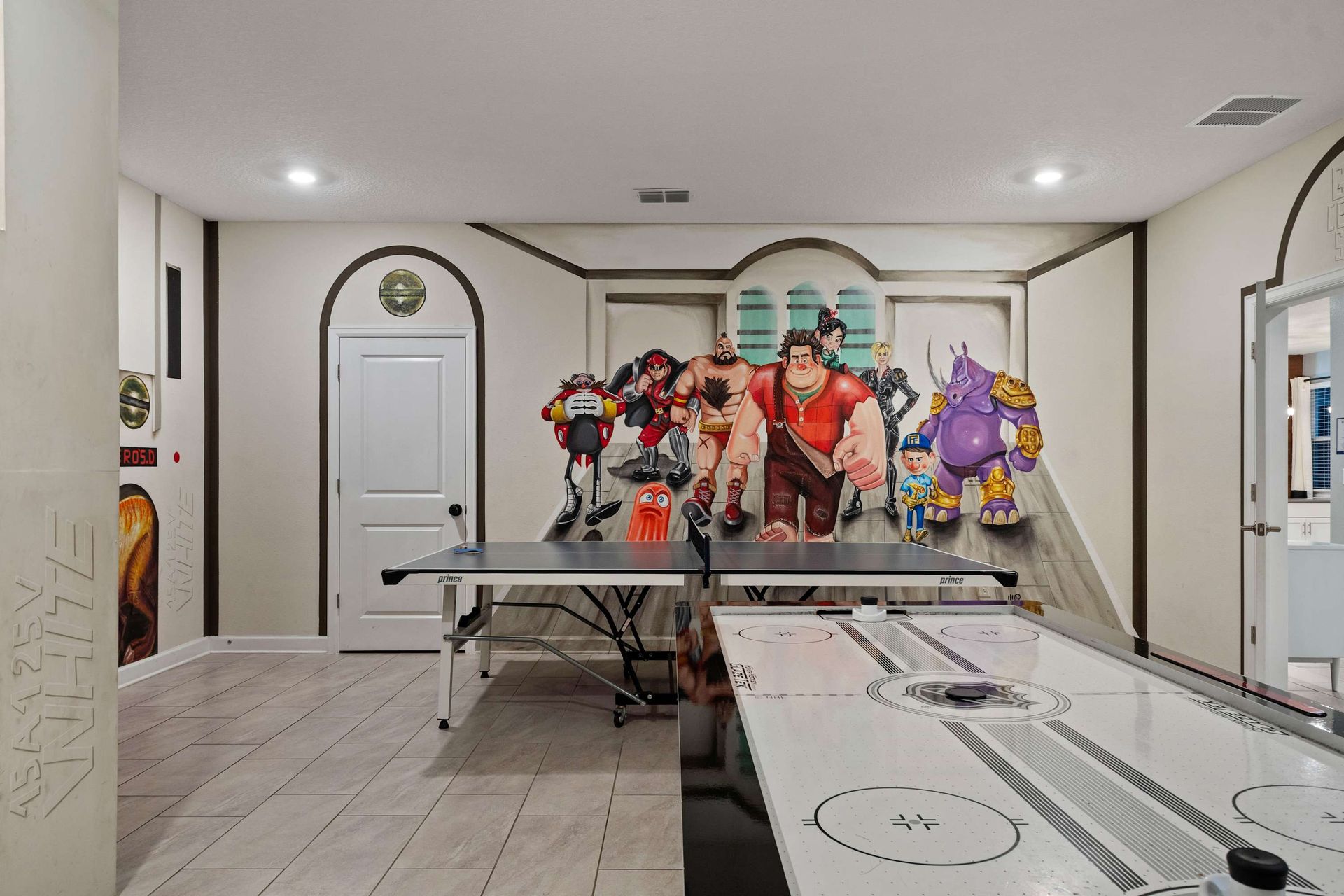 Unleash your inner gamer in this arcade-inspired room with ping pong, air hockey, and bold character murals!