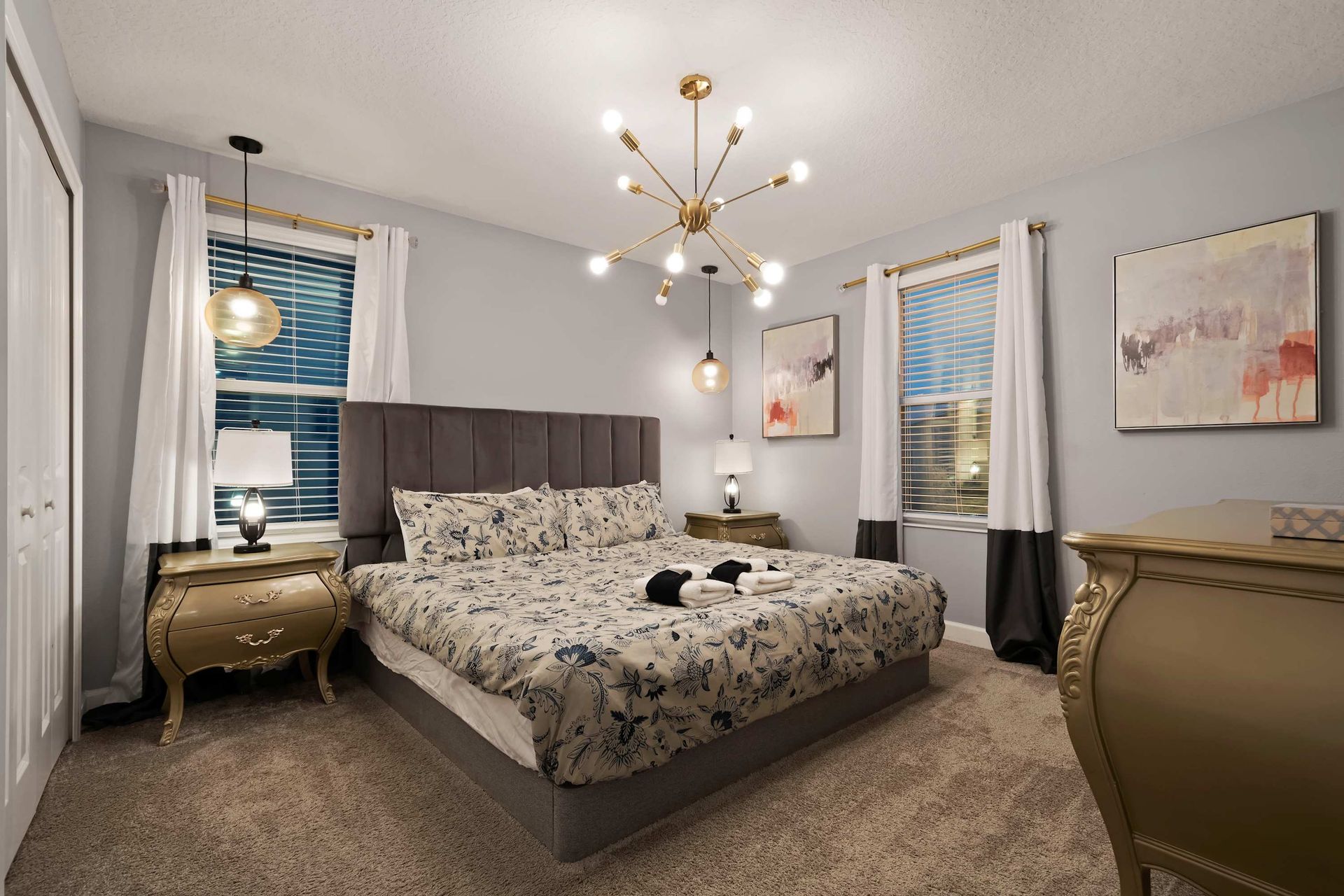 Elegant bedroom retreat with a plush king bed, chic lighting, and soft modern tones!