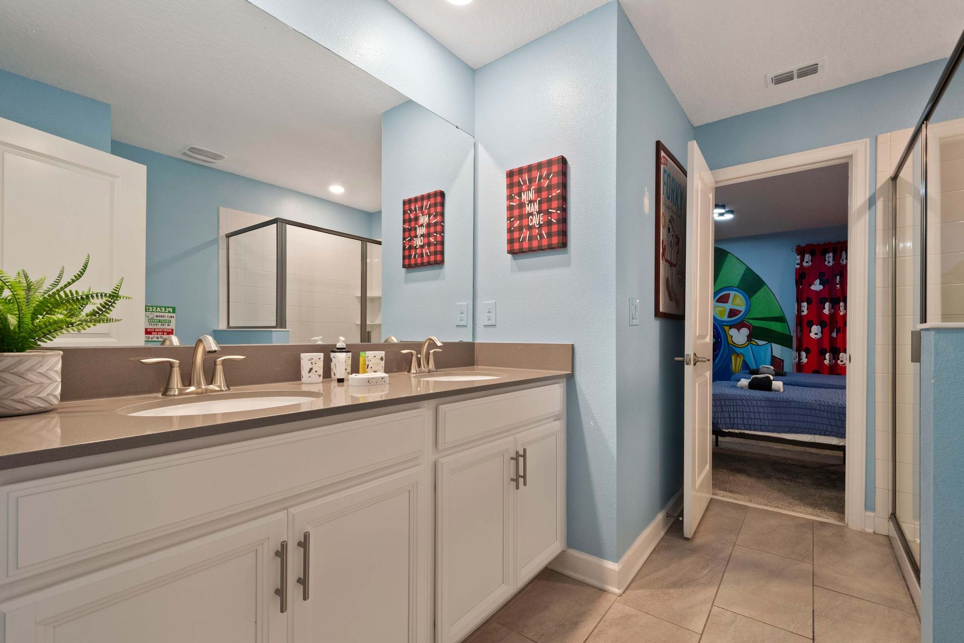 Bright and cheerful bathroom with double sinks, modern finishes, and a fun kid-friendly vibe!