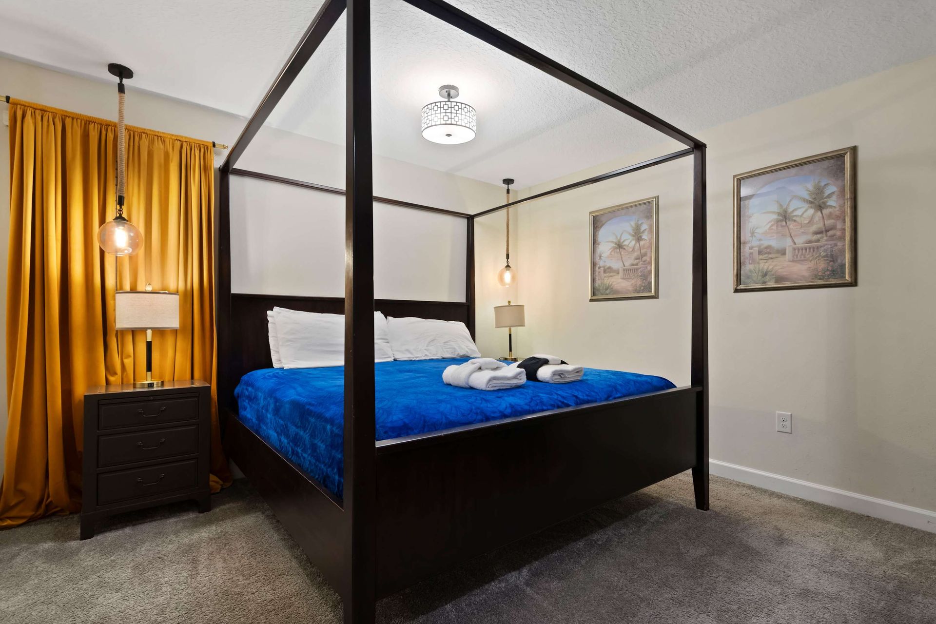 Bold and cozy bedroom featuring a striking canopy bed, rich colors, and warm lighting!