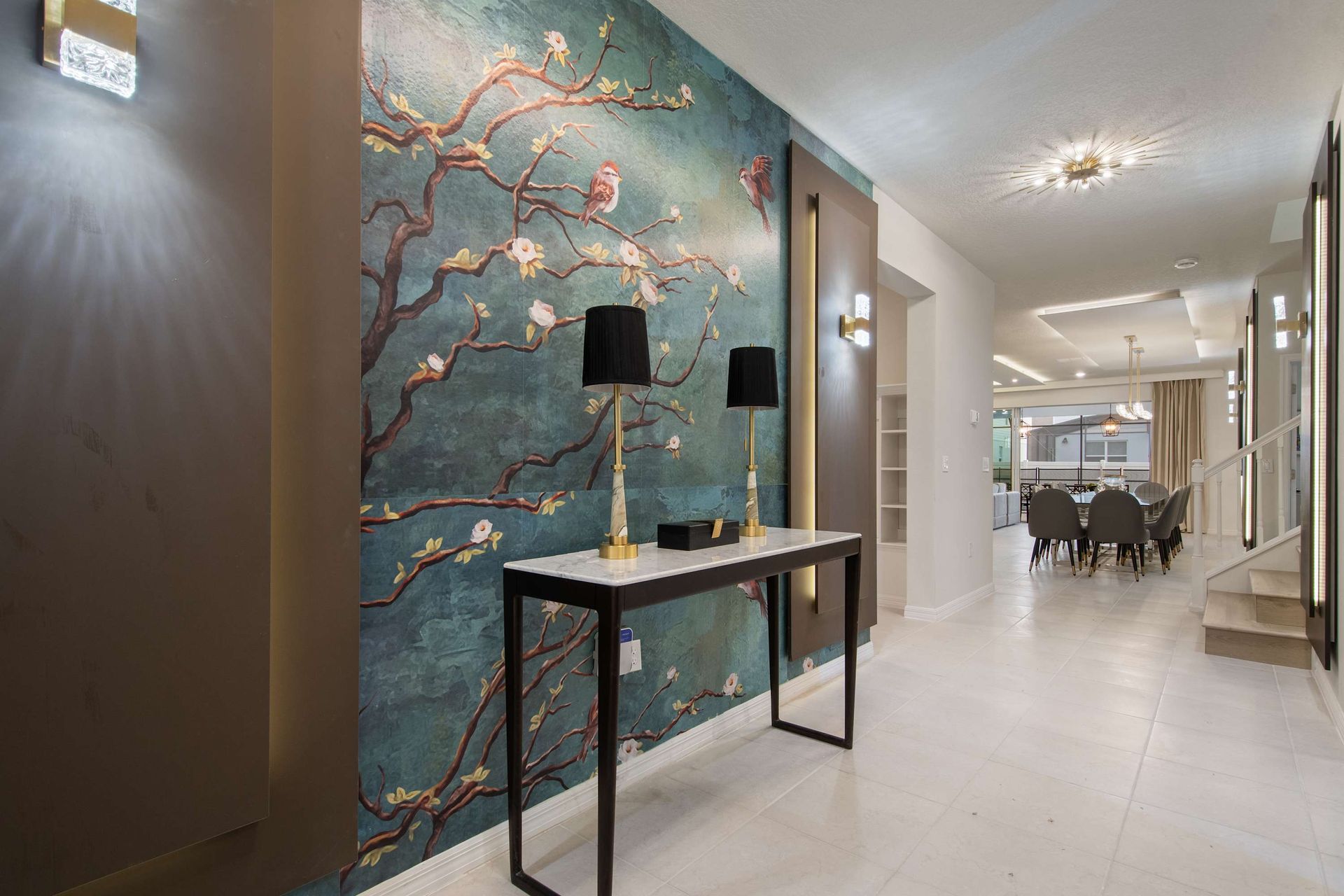 Elegant hallway with floral accent wall and warm ambient lighting throughout.