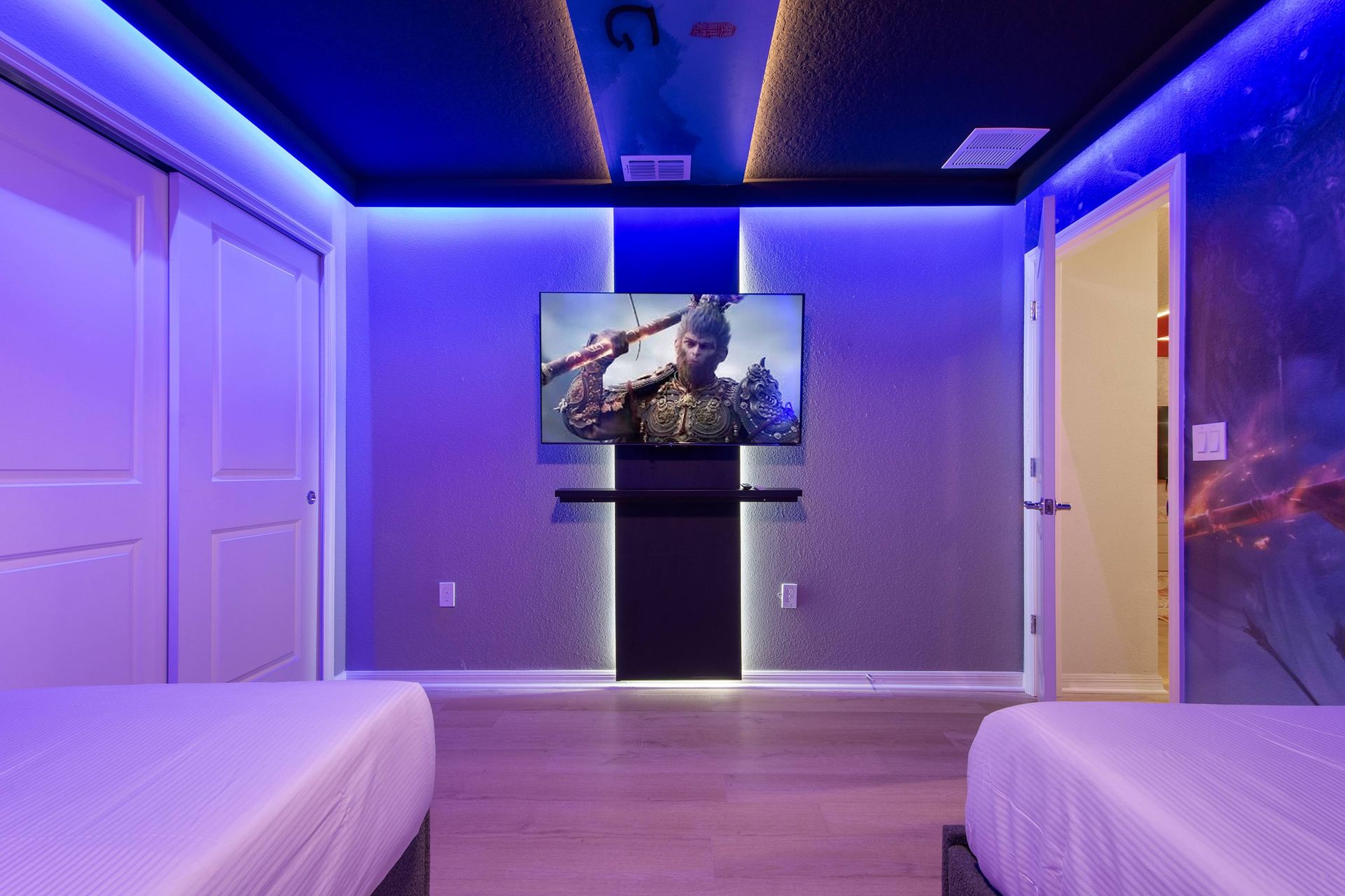 Heroic twin room with ambient lighting, wall murals, and action-packed TV setup.
