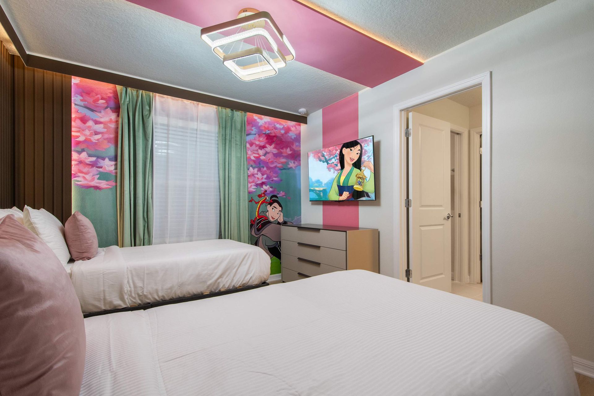 Whimsical twin room with vibrant cherry blossom murals and cozy bedding charm.