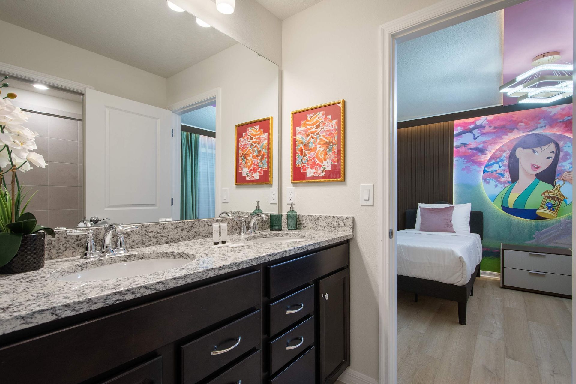 Stylish bathroom with granite counters and double sinks, steps from themed room.