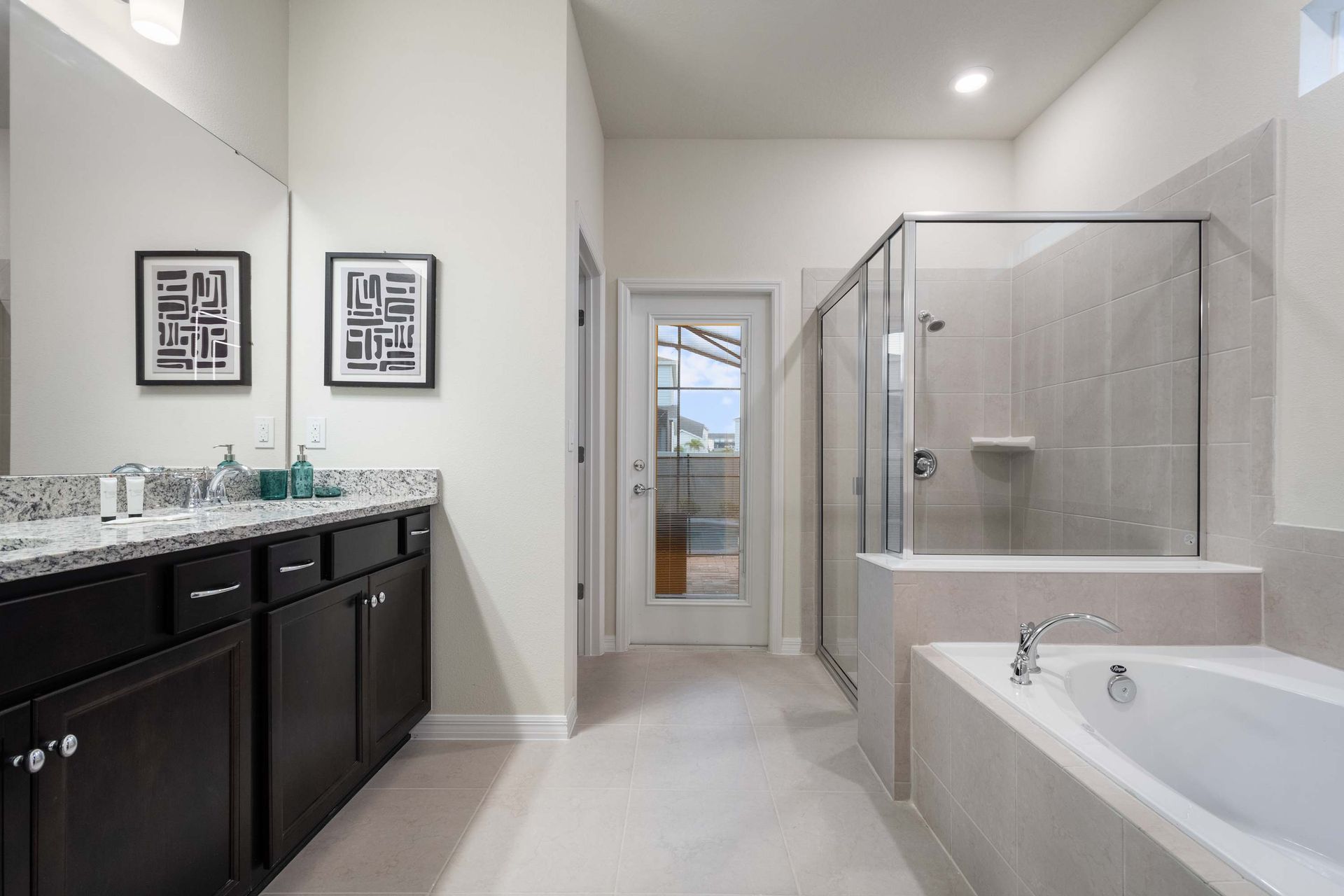 Spacious spa-style bathroom with walk-in shower, soaking tub, and double vanity.